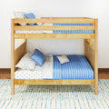 Solid wood bunk bed with blue quilted bedding, star-patterned white sheets and decorative pillows in a modern kids' bedroom