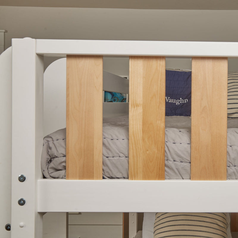 Close-up of a modern children's bunk bed with white painted frame, natural wood slats, gray quilt and striped pillow