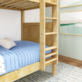 Light wood bunk bed ladder and lower bed with light blue quilt and white pillow in a modern kid's bedroom with coastal wall art and patterned rug