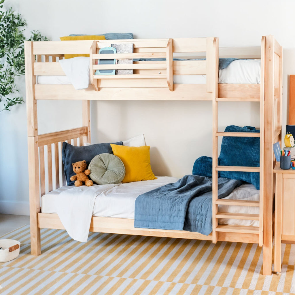 Natural wood twin bunk bed with ladder in modern kids' bedroom, blue and yellow pillows, teddy bear on lower bunk, striped rug and cozy bedding