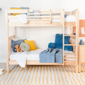 Light wood bunk bed in modern children's bedroom with blue armchair, yellow pillows, teddy bear and striped rug