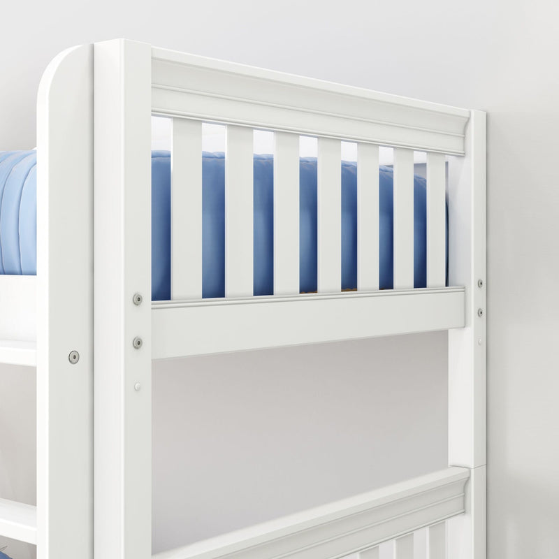 Close-up of white wooden crib railing with vertical slats and blue bedding, modern nursery baby crib guardrail and safety