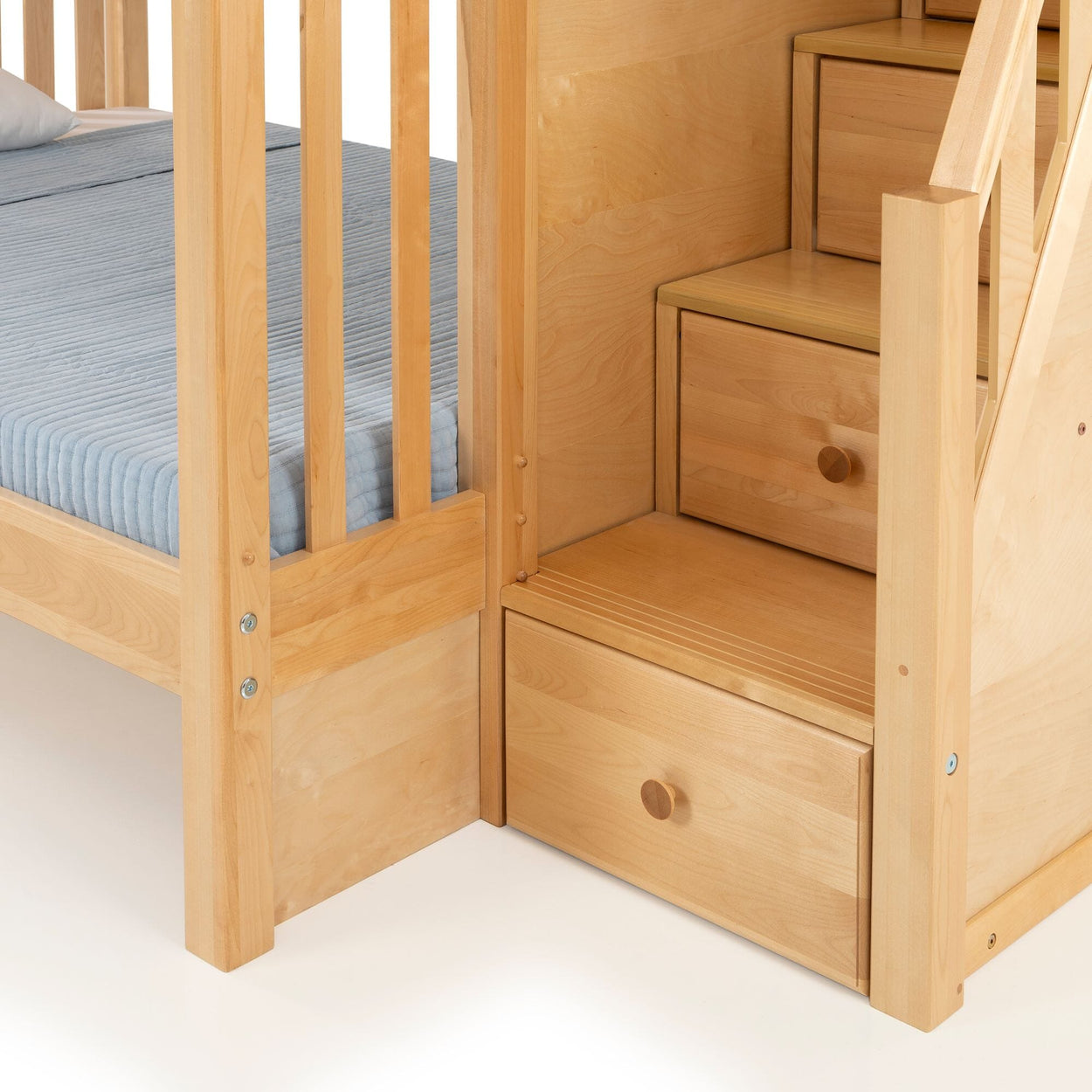 Light natural wood bunk bed with built-in storage stairs and pull-out drawer, blue fitted mattress, kids bedroom furniture