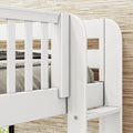 Close-up of white wooden bunk bed guardrail and ladder with safety rail, mattress and neutral bedding against woven wood textured wall — modern kids loft bed detail