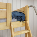 Close-up of a natural wood loft bunk bed ladder and side rail with a blue knitted throw blanket with tassels on the mattress against a white paneled wall