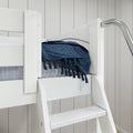 White wooden loft bed with ladder and navy blue fringed woven throw on gray mattress in modern coastal bedroom