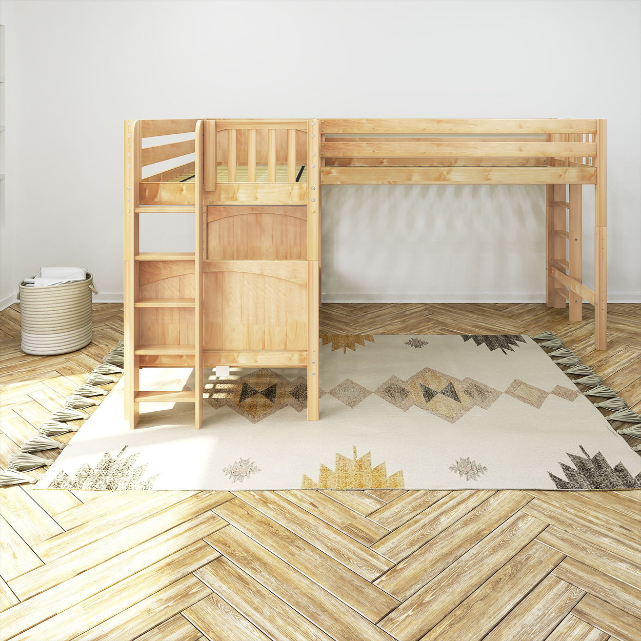Wooden loft bed with ladder in a bright room with geometric rug and herringbone wood flooring.