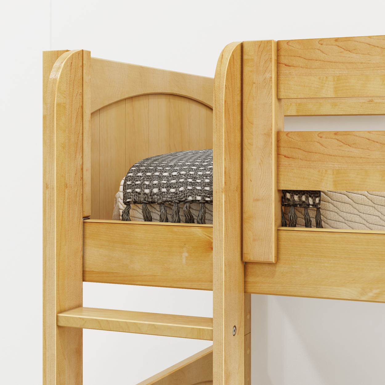 Wooden bunk bed corner with soft mattress and decorative blanket.