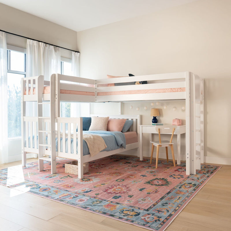 White wooden bunk bed in bright kids bedroom with pastel pink and blue bedding, study desk and lamp, sheer curtains and floral area rug