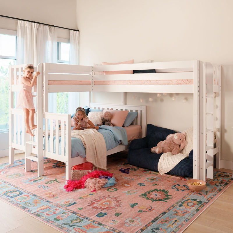 Two children playing on a white kids bunk bed in a cozy girls' bedroom with pastel bedding, plush toys, string lights, and a patterned rug