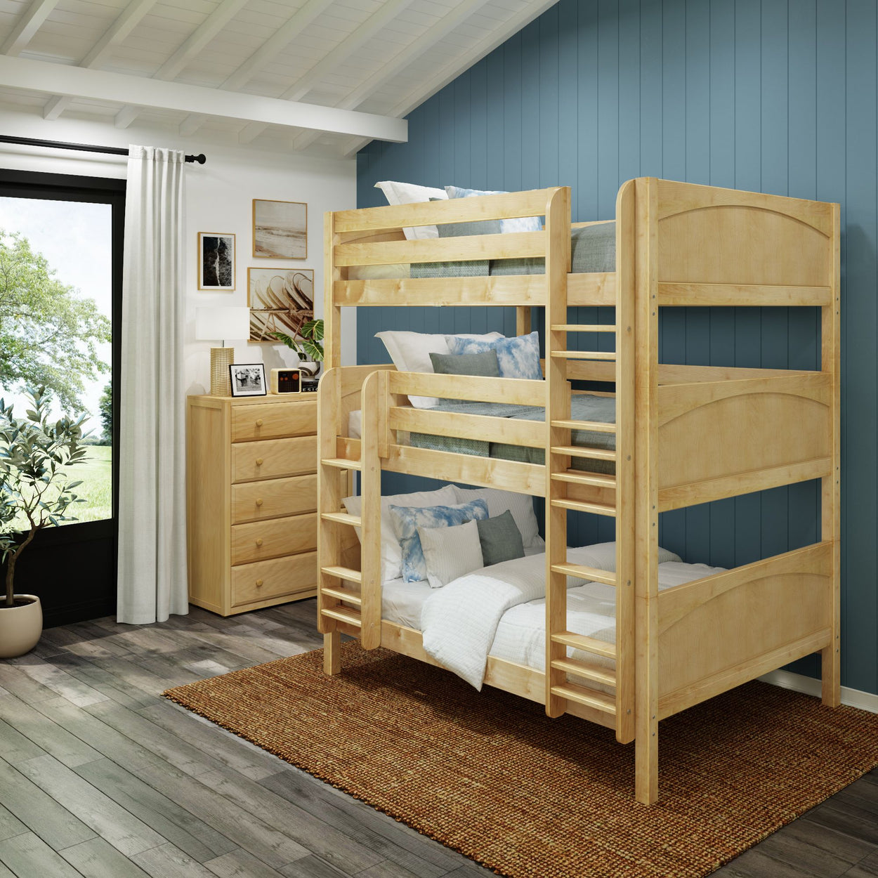 Wooden bunk bed in a cozy, modern bedroom with blue accent wall and wooden furniture.