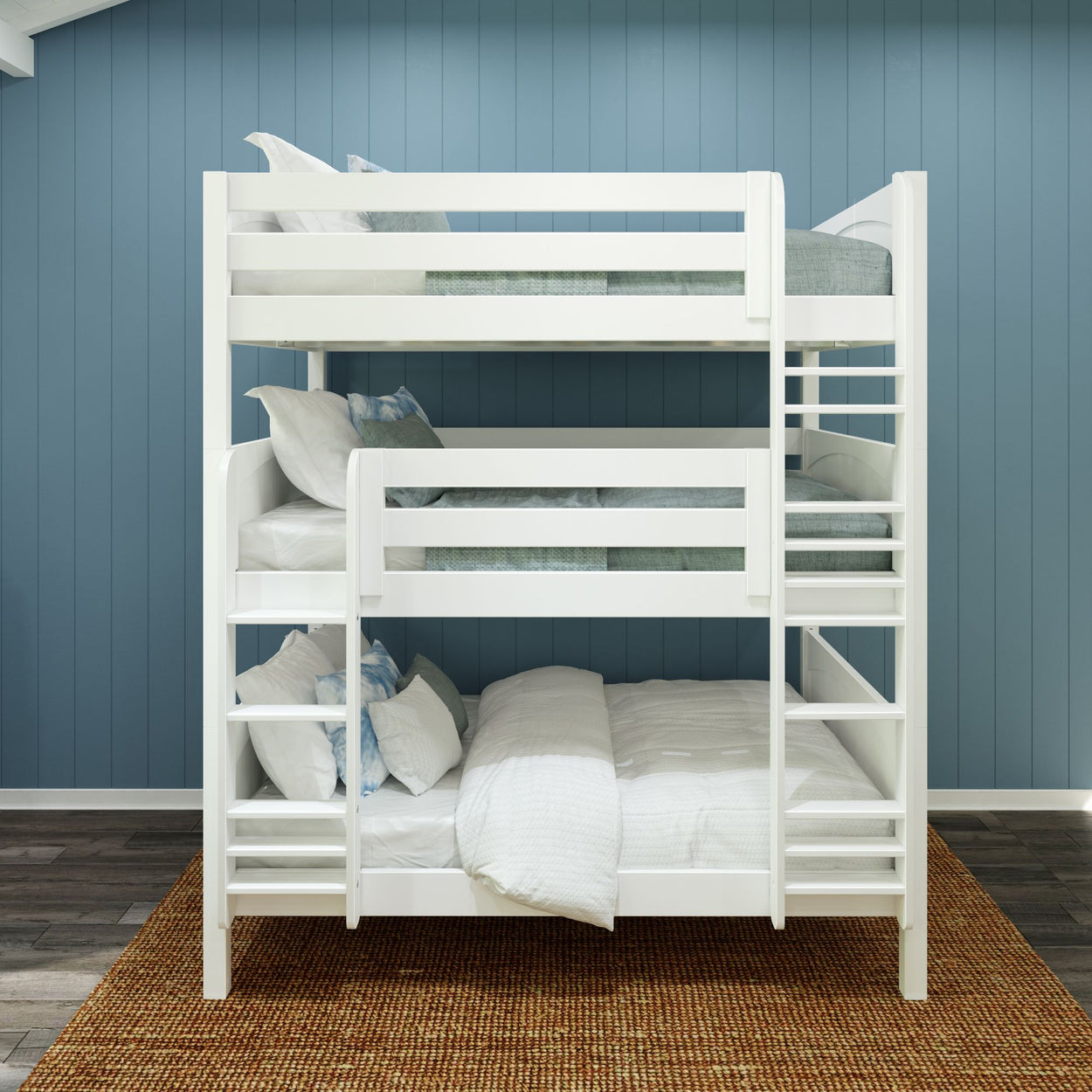 White triple bunk bed in a modern bedroom with blue walls and wooden flooring.