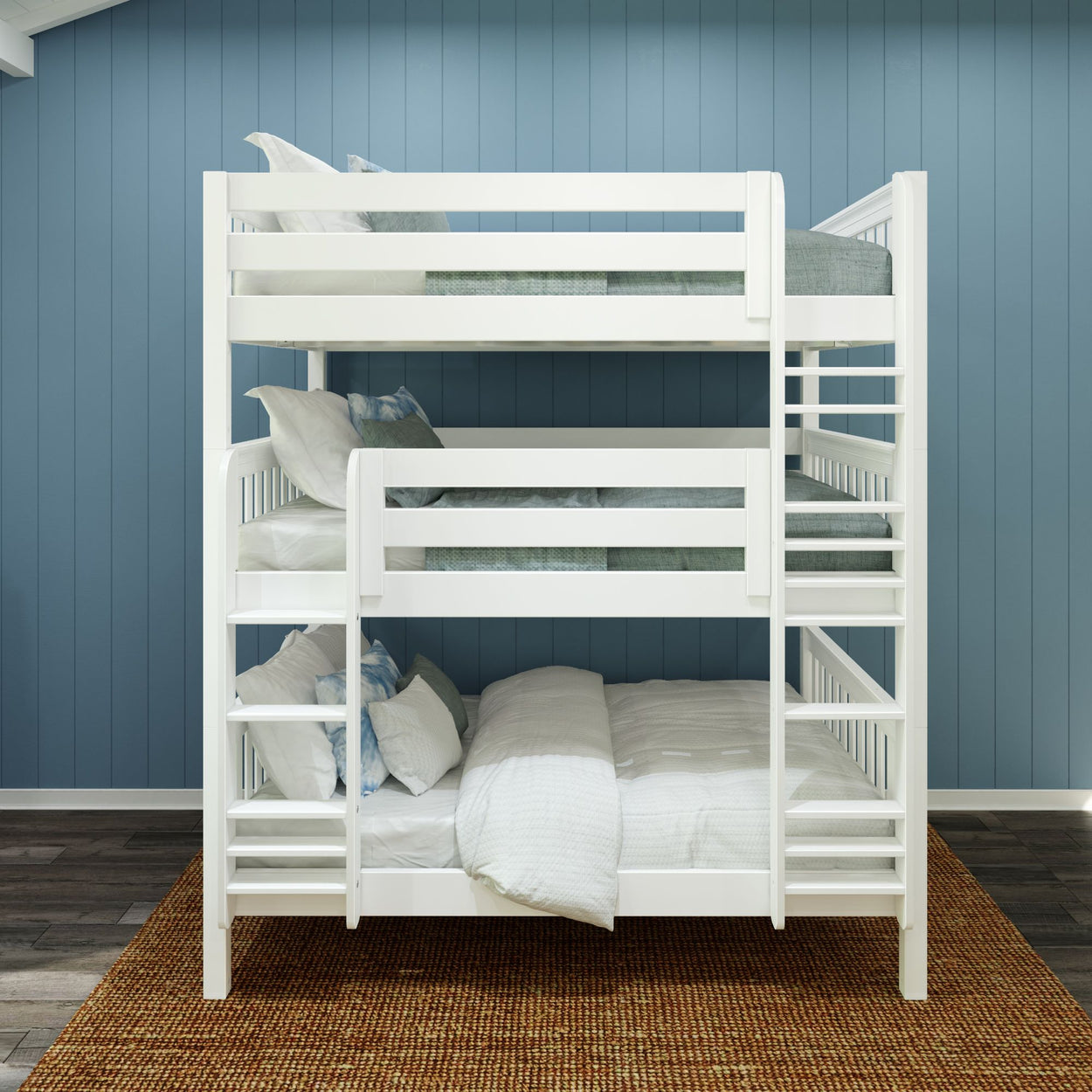 White triple bunk bed with cozy pillows and blankets in a stylish blue-walled bedroom.