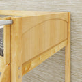 Close-up of light maple wooden bed frame footboard with arched panel and metal support rail against textured wallpaper, showing natural wood grain for modern rustic bedroom furniture