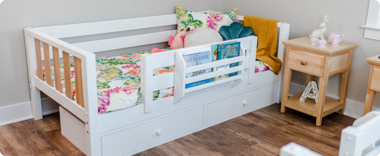 Children's bed with toys and bedding in a room setting.
