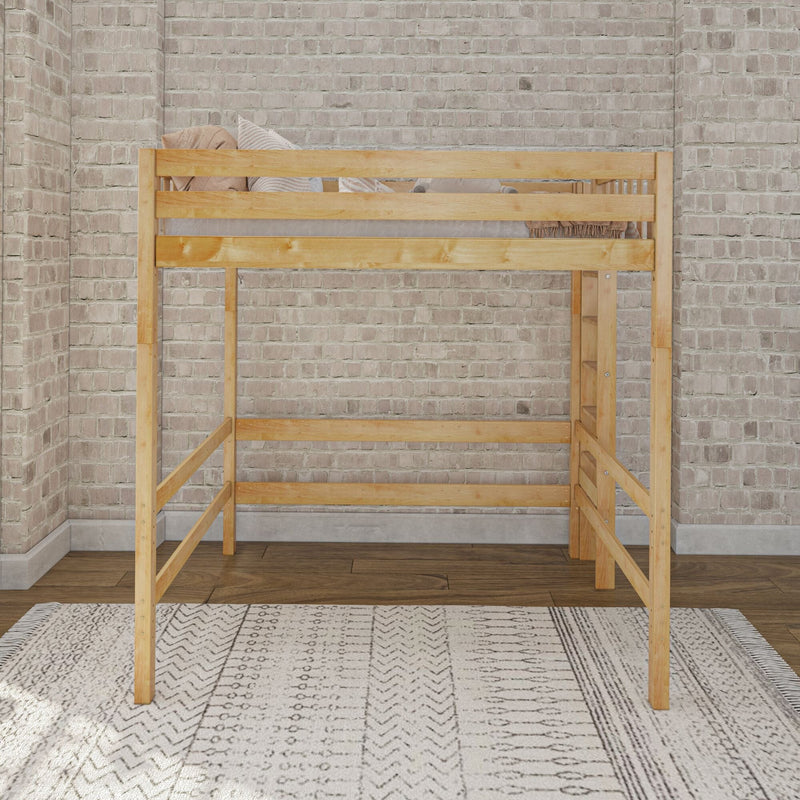 Solid natural wood loft bed with railing, neutral striped pillows and throw, patterned area rug and exposed brick wall in modern industrial bedroom