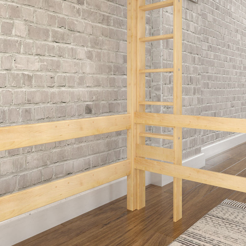 Light wood loft bed frame against a whitewashed brick accent wall in a modern industrial bedroom with hardwood floor