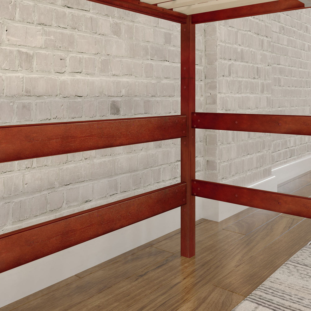 Wooden loft bed frame against exposed white brick wall and hardwood floor.