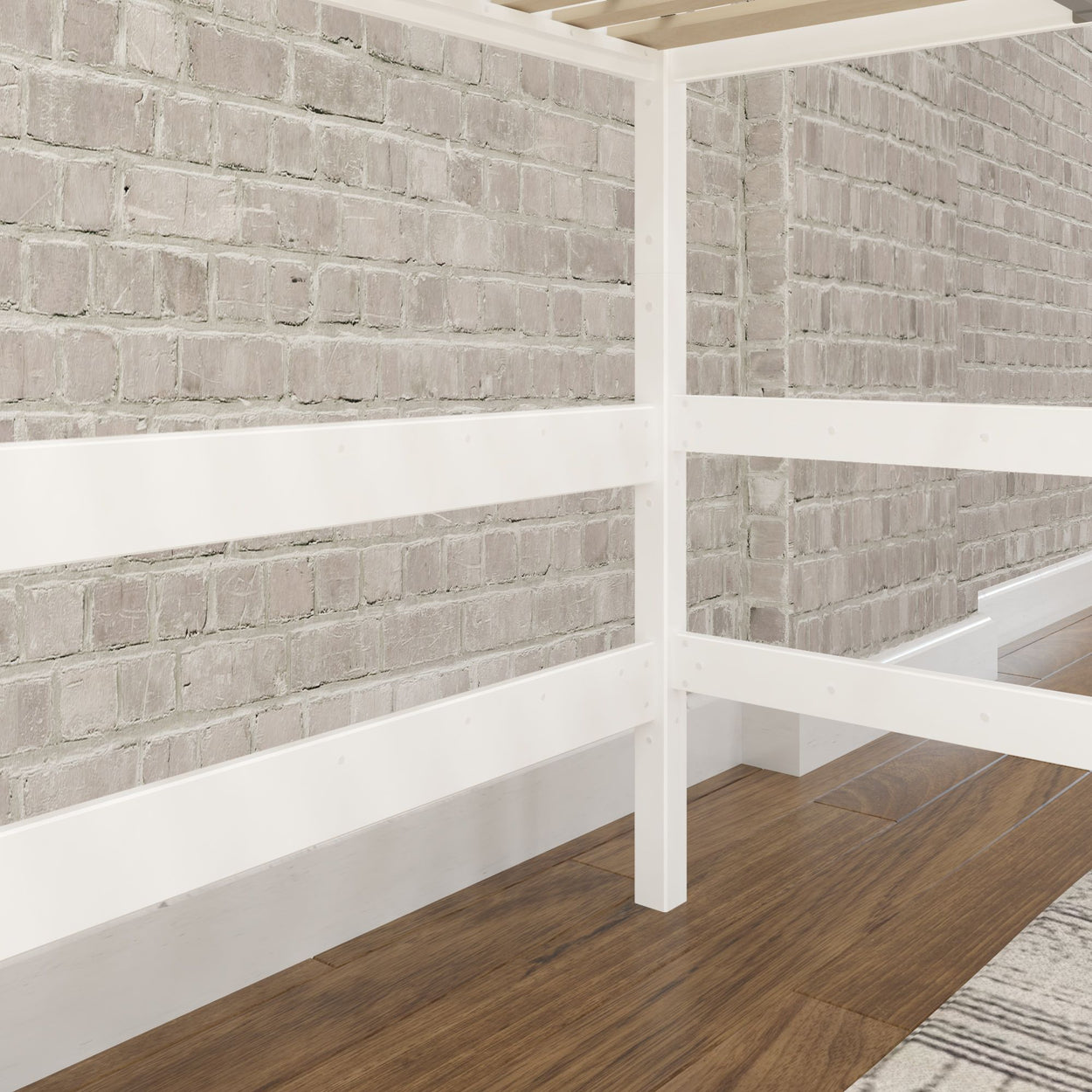 White wooden bed frame against exposed brick wall with hardwood floor.