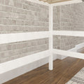 Close-up interior of painted white brick wall with white wooden railing and dark hardwood floor