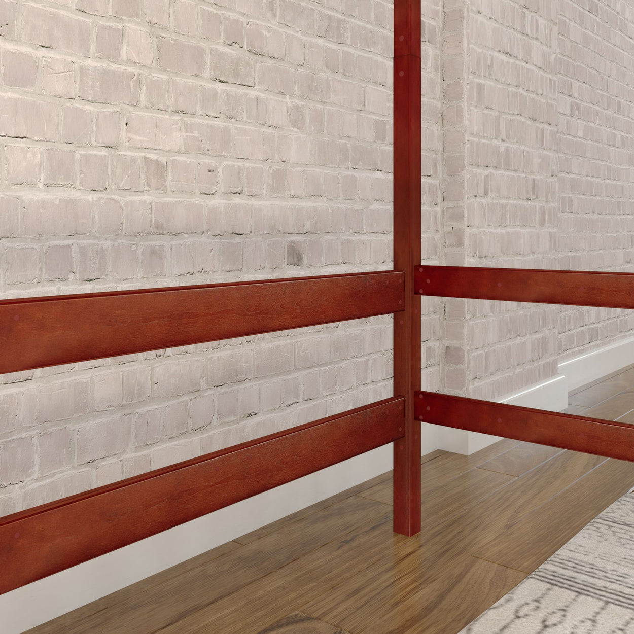 Red wooden bed frame with white brick wall backdrop and hardwood flooring in a modern bedroom.