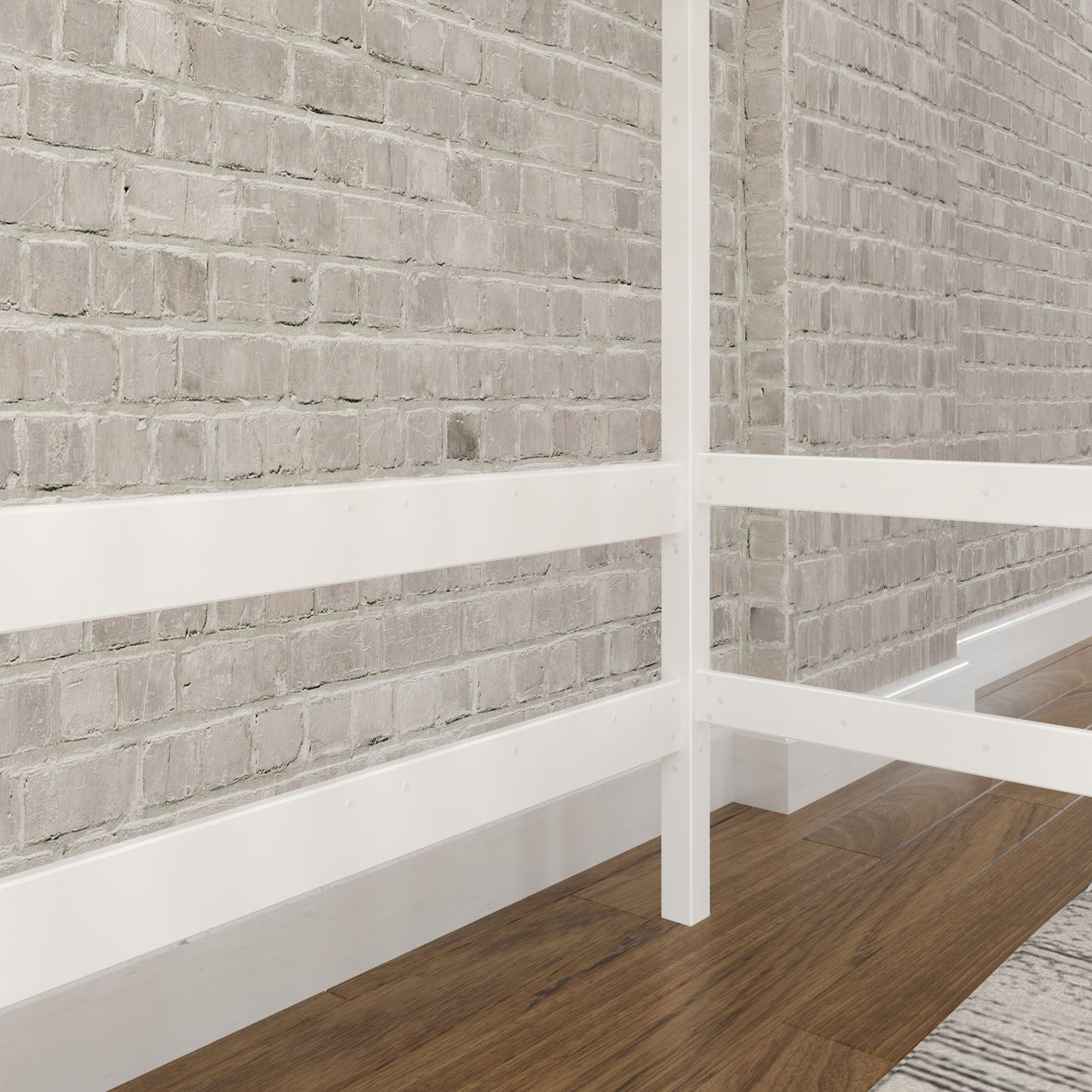 White metal bed frame against a modern brick wall, featuring hardwood flooring for a contemporary bedroom design.