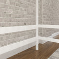 Whitewashed exposed brick interior wall with white-painted wooden frame and walnut hardwood floor in modern industrial farmhouse style