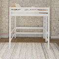 Modern white wooden loft bed with guardrails, beige striped pillows and throw against an exposed brick wall and patterned rug