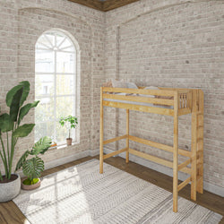 Wooden loft bed in an airy, natural light-filled room with brick walls, indoor plants, and a patterned rug.