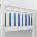 Close-up of white wooden baby crib rail with vertical slats and blue bedding, modern nursery safety rail detail