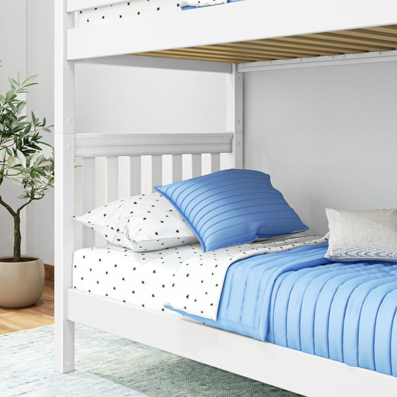 White wooden bunk bed with blue quilted pillows, star-print sheets, visible wooden slats and potted plant in a modern kids' bedroom