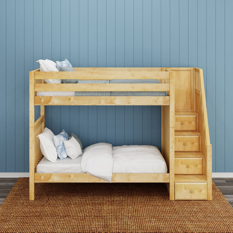 Wooden bunk bed with built-in storage stairs, white bedding and pillows against a blue paneled wall — space-saving kids' bedroom design
