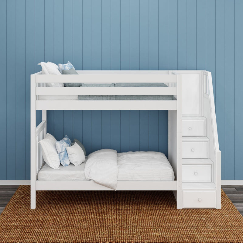 White wooden bunk bed with built-in stair storage and drawers, white bedding and blue accent pillows against a coastal blue paneled wall on a woven jute rug