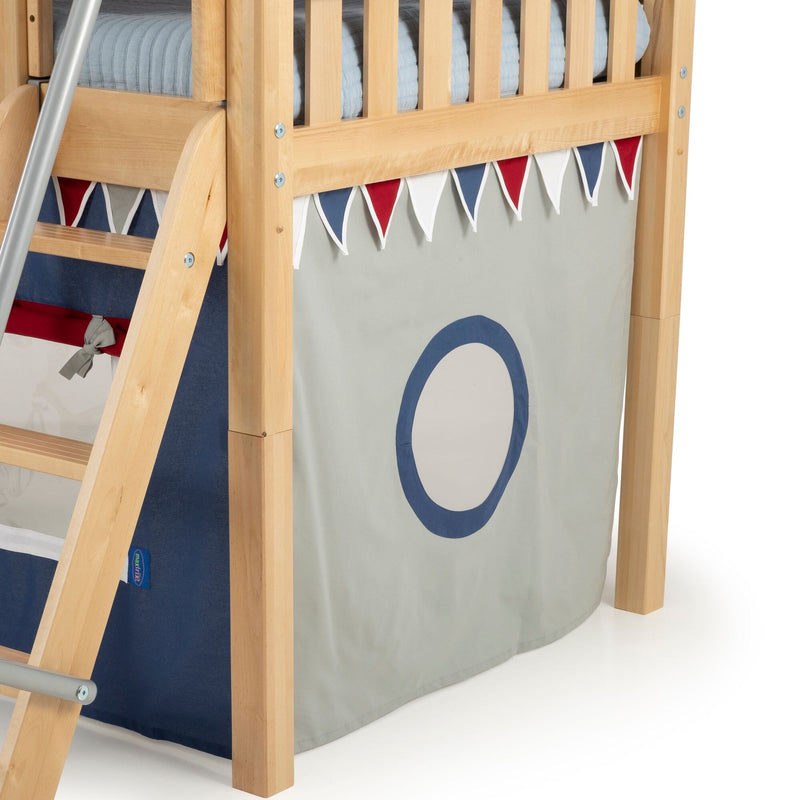 Natural wood children's loft bunk bed with ladder, navy and red triangle bunting and light gray play-tent panel featuring a blue porthole