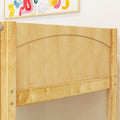 Close-up of light maple wood bed headboard with curved top slat design and natural finish against a white bedroom wall with colorful framed artwork above