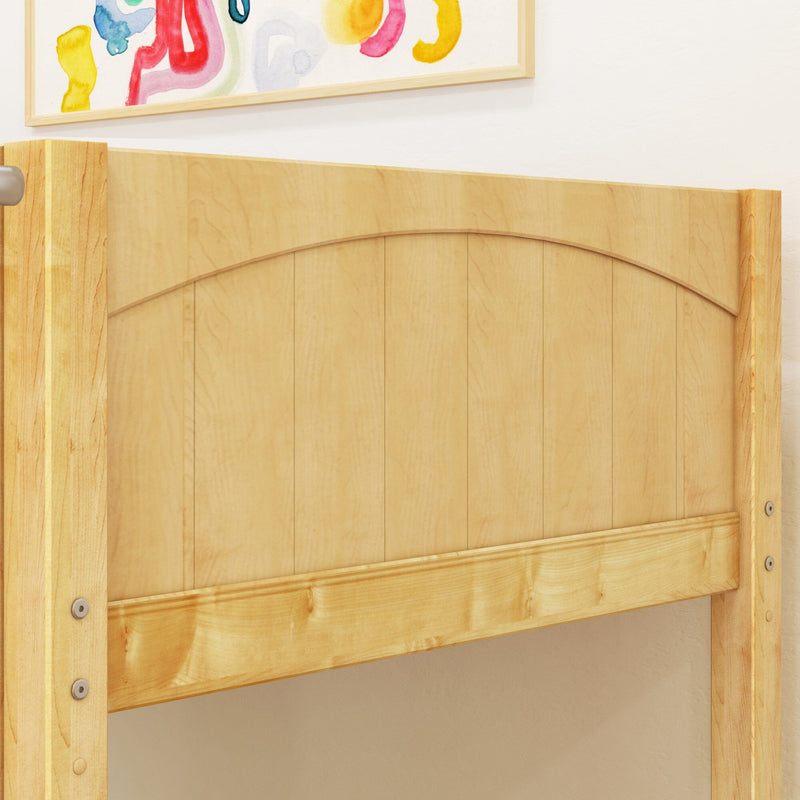 Close-up of light maple wood bed headboard with curved top slat design and natural finish against a white bedroom wall with colorful framed artwork above