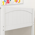 Close-up of white wooden panel headboard with arched top and visible hardware beneath colorful abstract wall art, modern nursery or kids bedroom decor