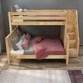 Light wood bunk bed with built-in stair drawers, twin-over-full layout and pink-gray bedding in a space-saving modern kids' bedroom