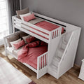 White wooden twin-over-full bunk bed with stair storage, pink bedding and pillows in a modern kids’ bedroom with hardwood floor and gray wall