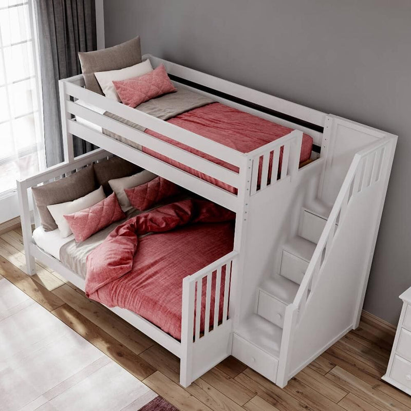White wooden twin-over-full bunk bed with stair storage, pink bedding and pillows in a modern kids’ bedroom with hardwood floor and gray wall