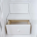 White dresser drawers with a partially open drawer revealing natural wood interior, minimalist closet storage