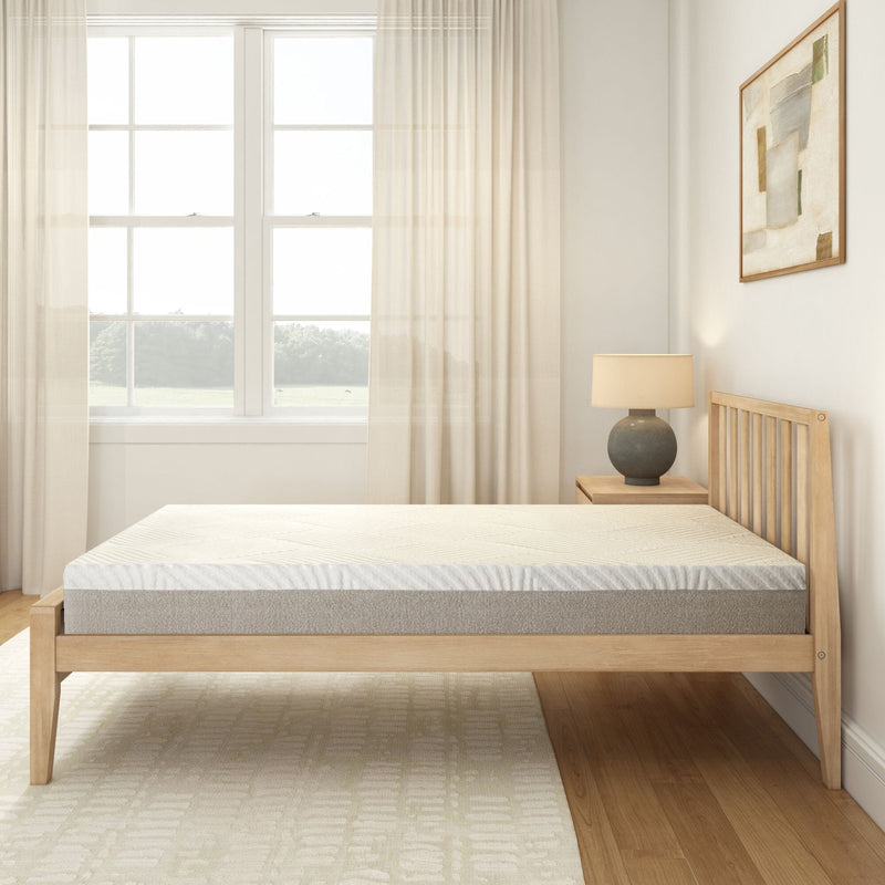 Wooden bed frame with mattress in a modern bedroom featuring large windows with sheer curtains.