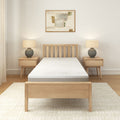 Minimalist bedroom with wooden bed frame, modern nightstands, and abstract wall art.