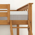 Wooden loft bed frame with ladder and mattress.