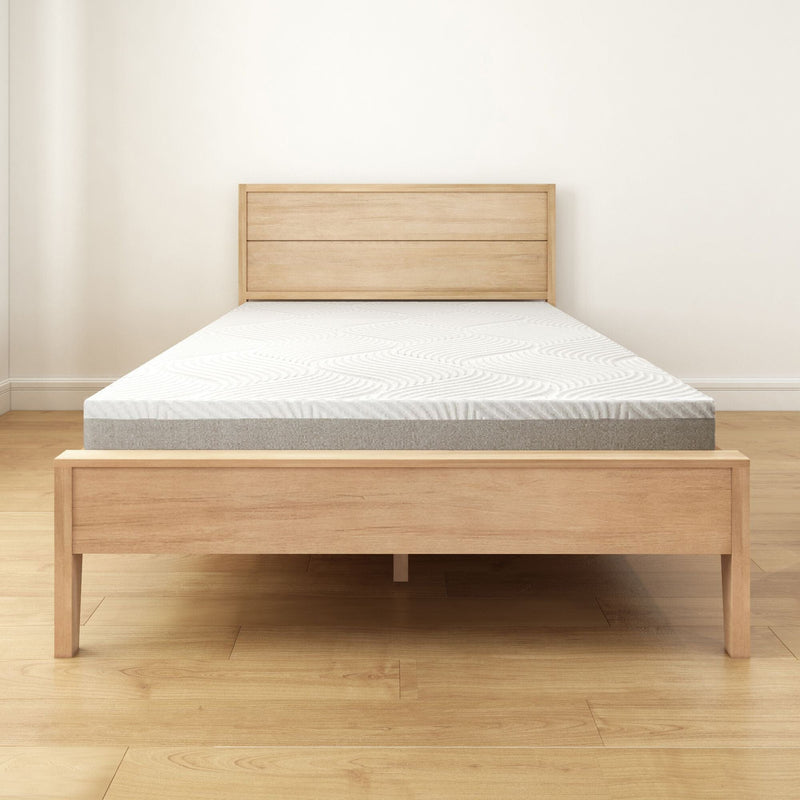 Minimalist wooden bed frame with a comfortable modern mattress in a bright room.