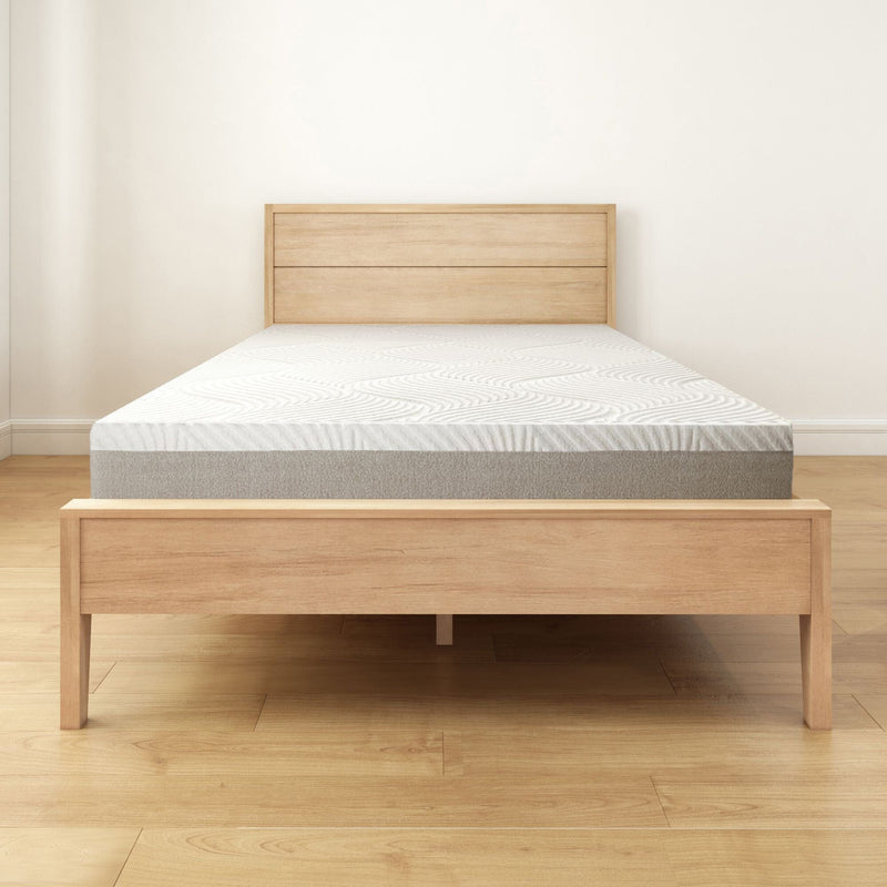 Modern wooden bed frame with comfortable mattress in minimalist bedroom setting.