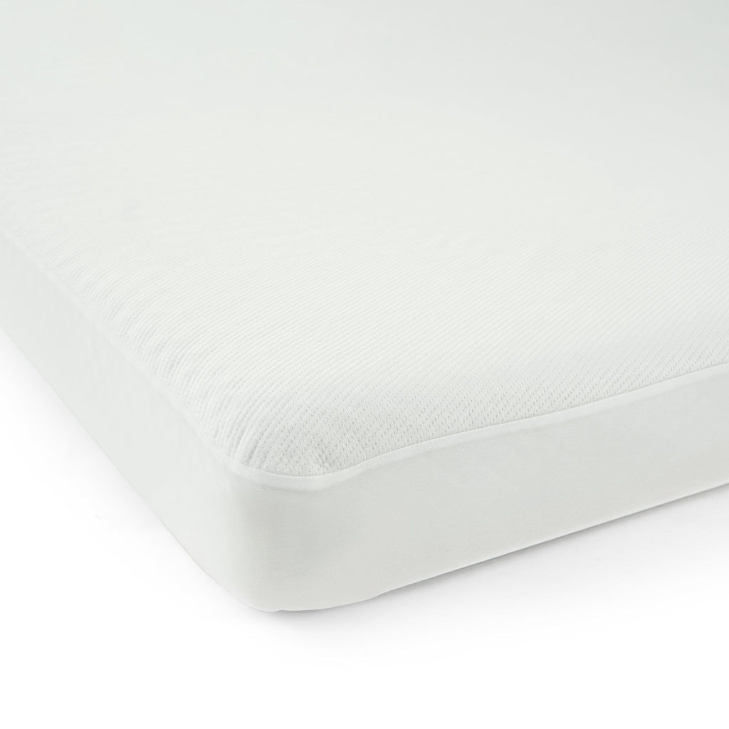 Close-up of soft white textured fabric folds for clothing and upholstery.