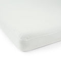 White memory foam mattress corner close-up, showcasing soft, breathable fabric texture.
