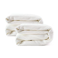Folded white towels on a white background, perfect for home and hotel bathroom use.