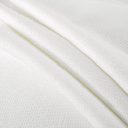 White textured fabric close-up, highlighting soft and smooth material ideal for clothing.
